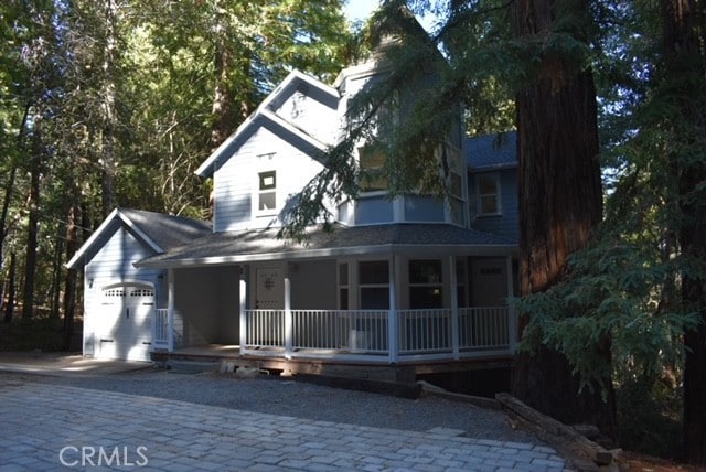 view of front of property with a porch and a garage