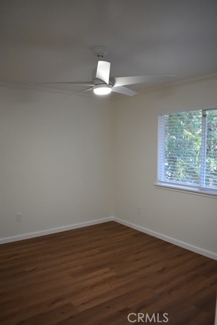 spare room featuring ornamental molding, dark hardwood / wood-style floors, and ceiling fan