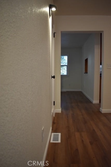 corridor with dark hardwood / wood-style floors