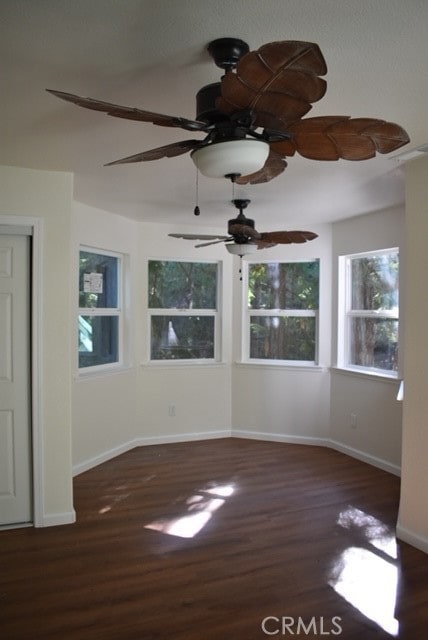 spare room featuring dark hardwood / wood-style floors and ceiling fan