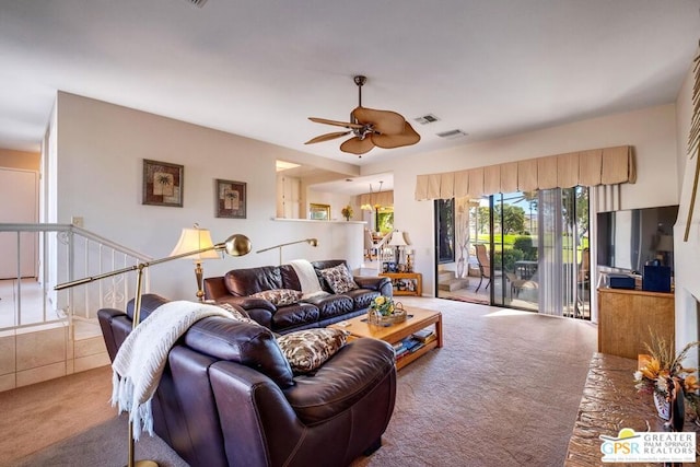 carpeted living room with ceiling fan