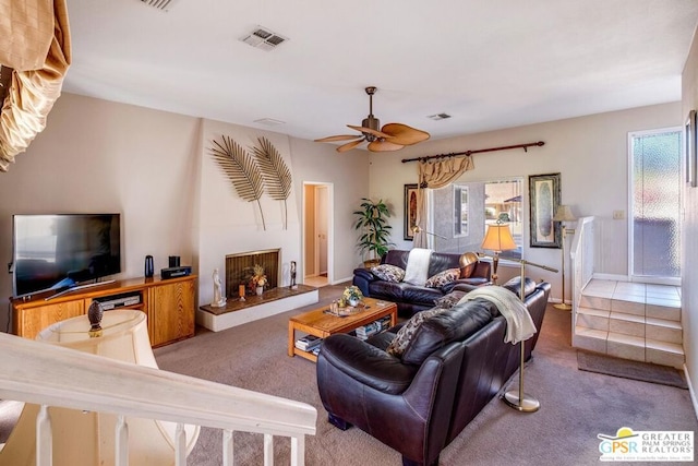 living room featuring carpet and ceiling fan