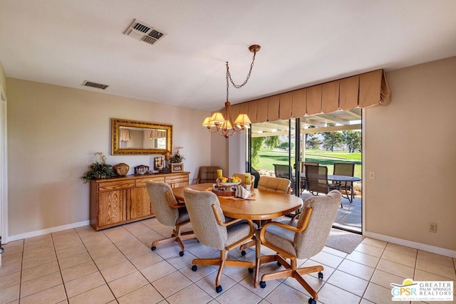 dining area featuring a chandelier and light tile patterned floors