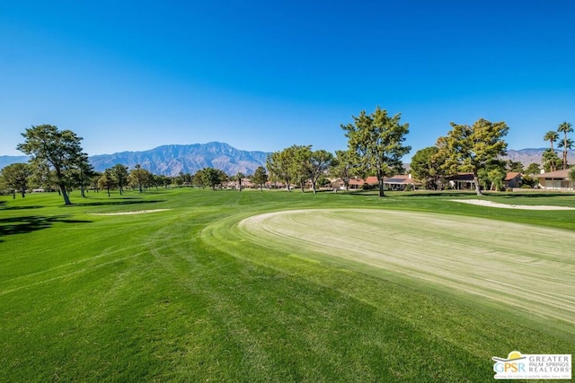 view of property's community featuring a mountain view and a lawn