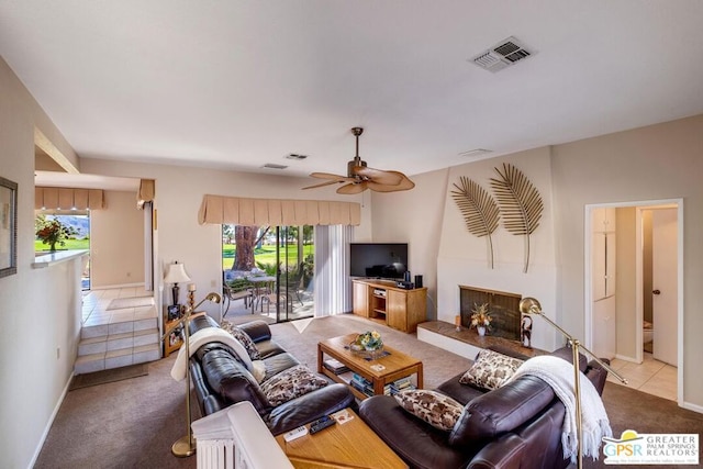 carpeted living room with a wealth of natural light and ceiling fan