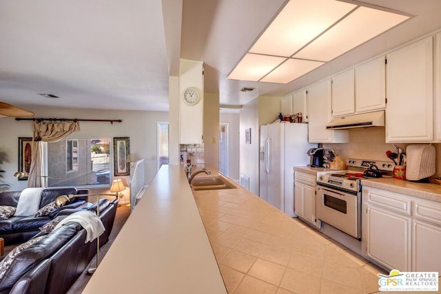 kitchen featuring sink, white cabinetry, white appliances, and tasteful backsplash