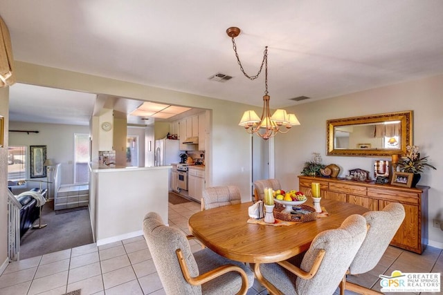 tiled dining area with a chandelier