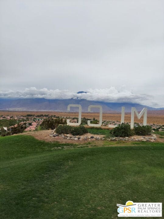 view of community featuring a yard and a mountain view