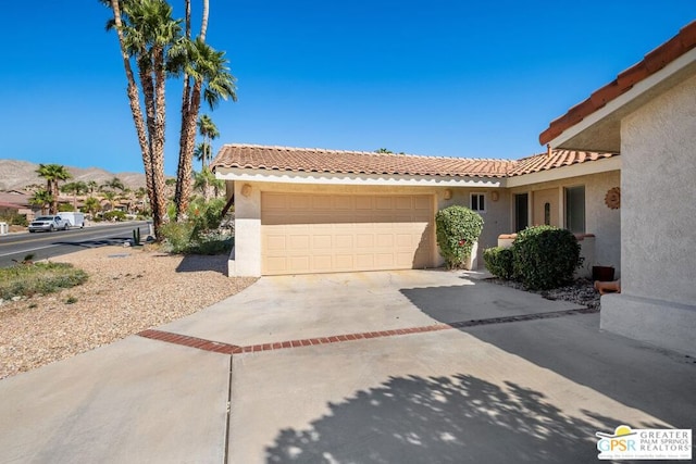 view of front of property featuring a garage and a mountain view