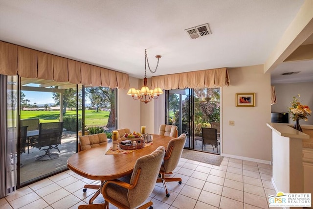 tiled dining area featuring an inviting chandelier