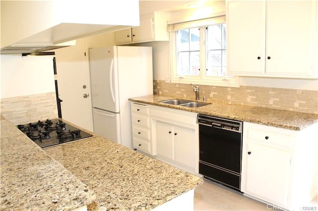 kitchen with black appliances, white cabinets, sink, and tasteful backsplash