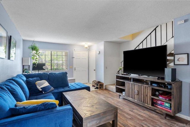 living room with hardwood / wood-style floors and a textured ceiling