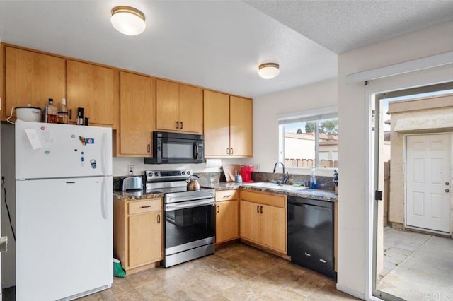 kitchen with black appliances, sink, and a textured ceiling