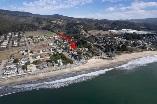 drone / aerial view with a water view and a view of the beach