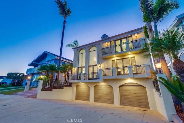 view of front of property with a balcony and a garage