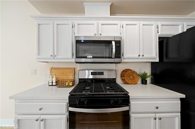 kitchen featuring appliances with stainless steel finishes and white cabinetry