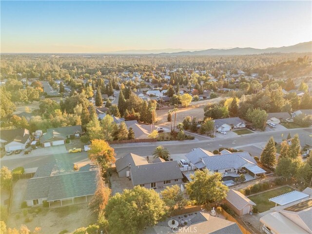 aerial view at dusk featuring a mountain view