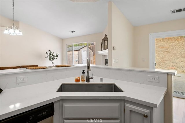 kitchen with dishwasher, gray cabinetry, a notable chandelier, and sink