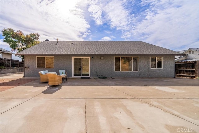 back of property with a patio area and an outdoor hangout area