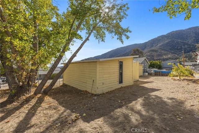 view of outbuilding featuring a mountain view