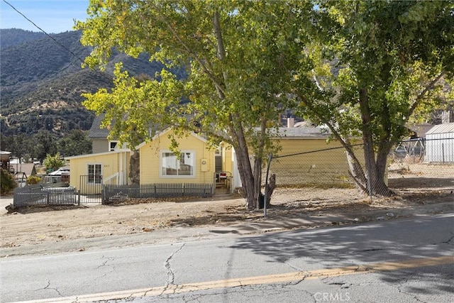 view of property hidden behind natural elements with a mountain view