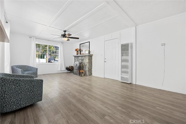 living room with hardwood / wood-style flooring, ceiling fan, and a fireplace