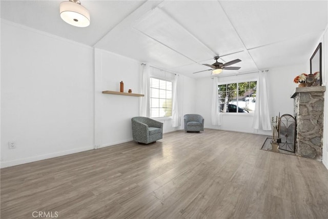 unfurnished living room featuring ceiling fan, a fireplace, and hardwood / wood-style flooring