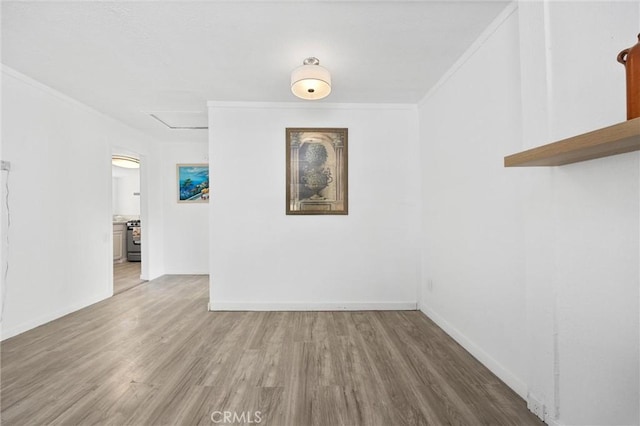 empty room featuring hardwood / wood-style flooring and ornamental molding