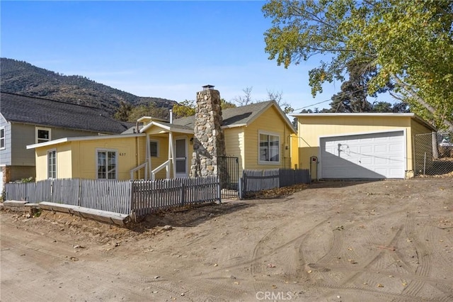 view of front of home with a mountain view and a garage