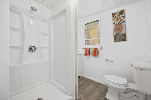 bathroom featuring hardwood / wood-style flooring, toilet, and walk in shower