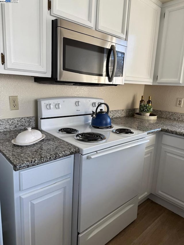 kitchen featuring white cabinets, white electric range, and dark hardwood / wood-style floors