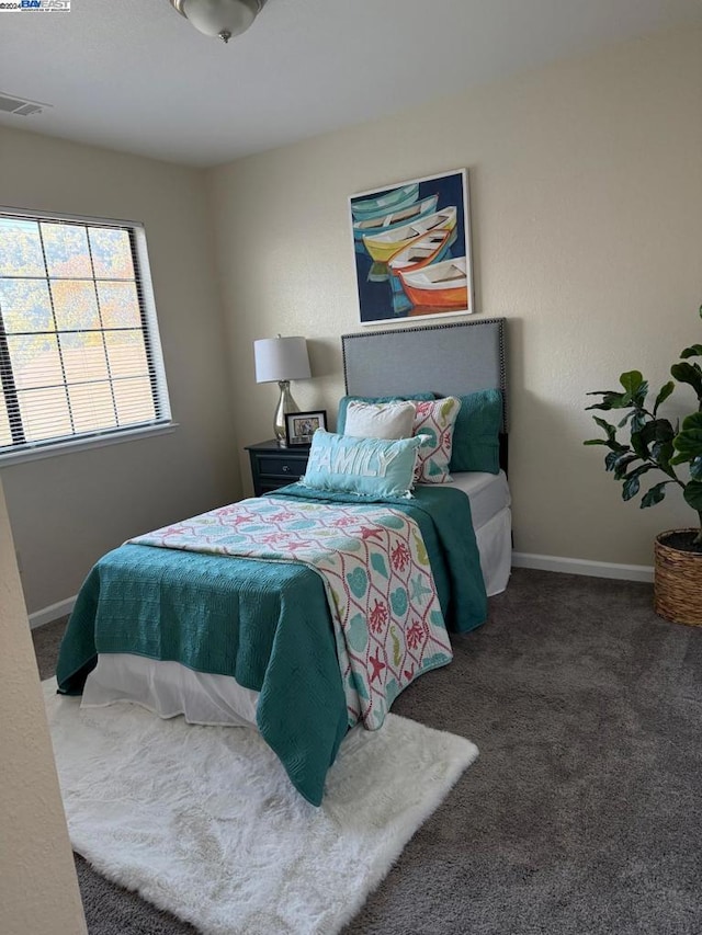 bedroom with dark colored carpet