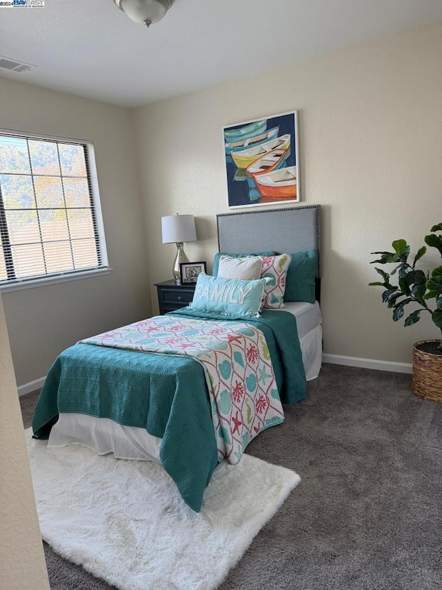 bedroom with dark colored carpet