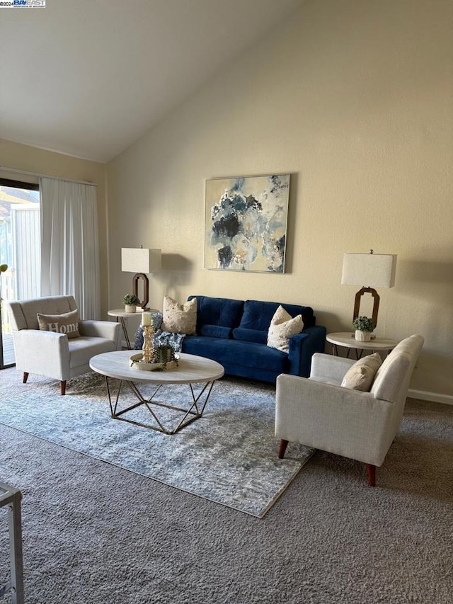 living room with carpet flooring and vaulted ceiling