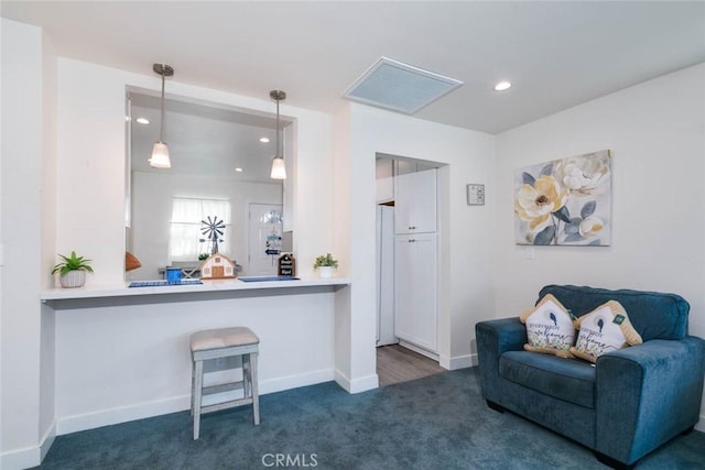 interior space featuring dark carpet, decorative light fixtures, and white refrigerator