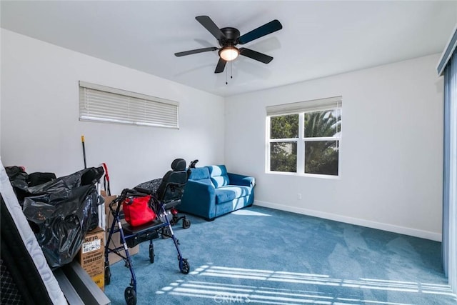 living area featuring carpet and ceiling fan