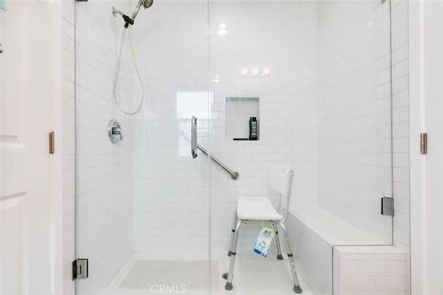 bathroom with a shower with door