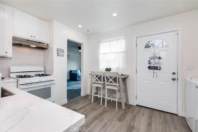 foyer with ceiling fan and light hardwood / wood-style flooring