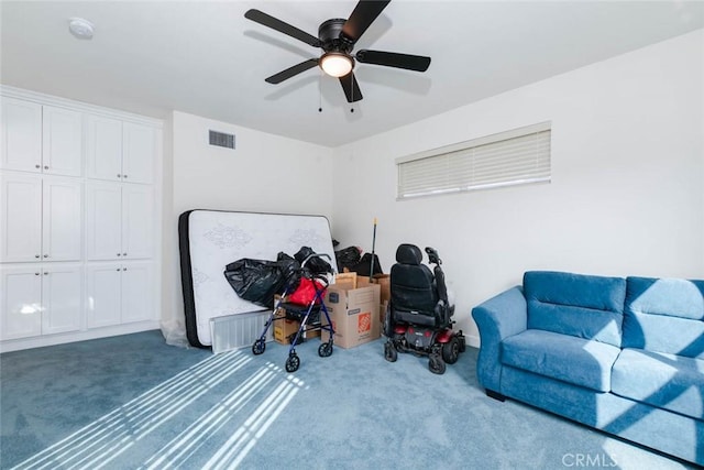 interior space with carpet flooring and ceiling fan