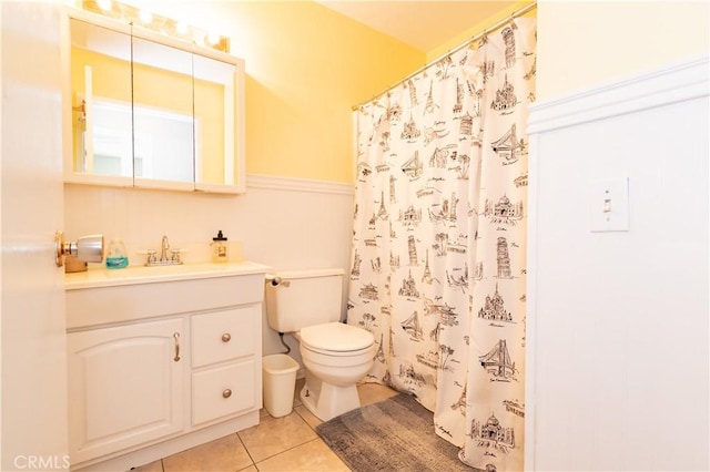 bathroom with toilet, vanity, tile patterned floors, and a shower with shower curtain