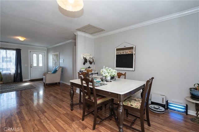 dining area featuring hardwood / wood-style flooring, ornamental molding, and baseboard heating