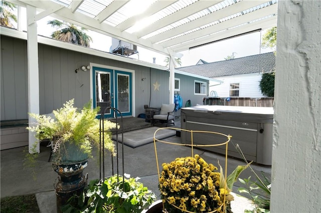 view of patio / terrace featuring french doors, a pergola, and a hot tub