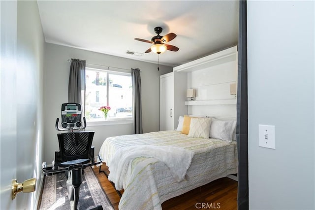 bedroom featuring dark hardwood / wood-style floors and ceiling fan