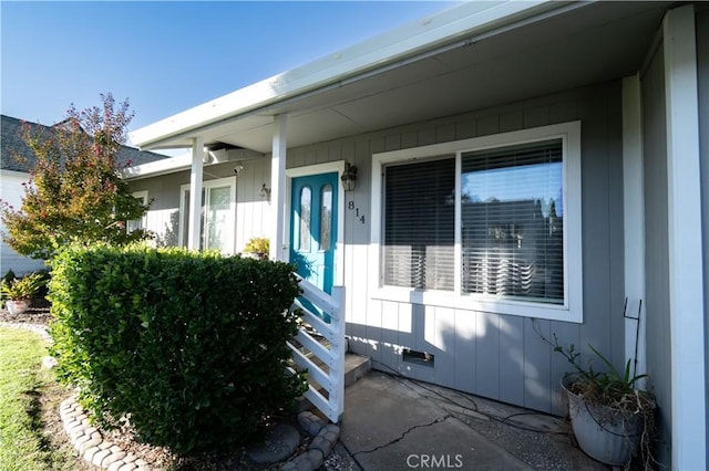 view of exterior entry featuring board and batten siding