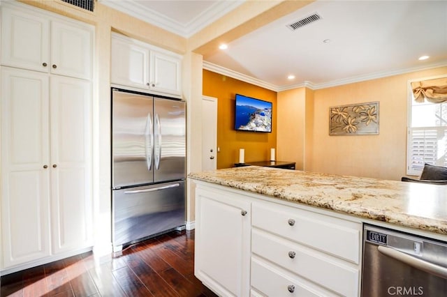 kitchen with white cabinetry, dark wood-type flooring, appliances with stainless steel finishes, and ornamental molding