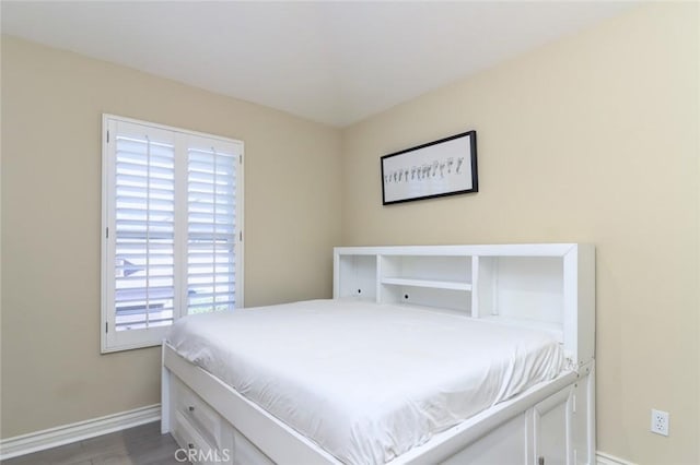 bedroom with dark wood-type flooring