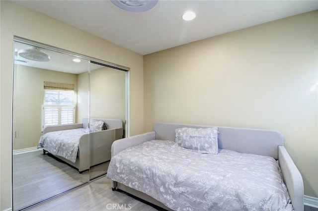 bedroom featuring wood-type flooring and a closet