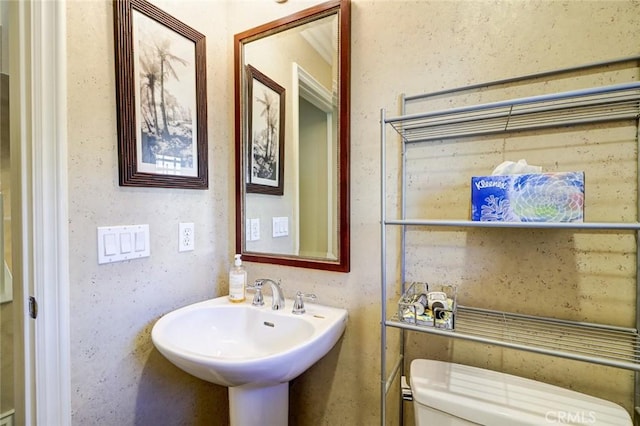 bathroom with toilet and sink