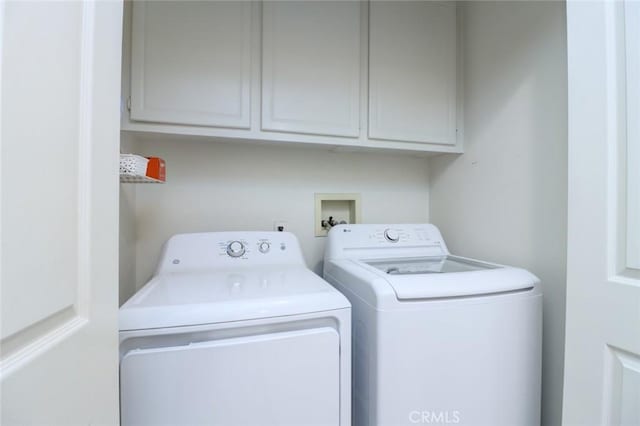 laundry area with cabinets and washing machine and dryer