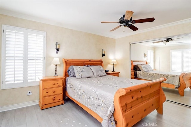 bedroom with a closet, ceiling fan, crown molding, and wood-type flooring